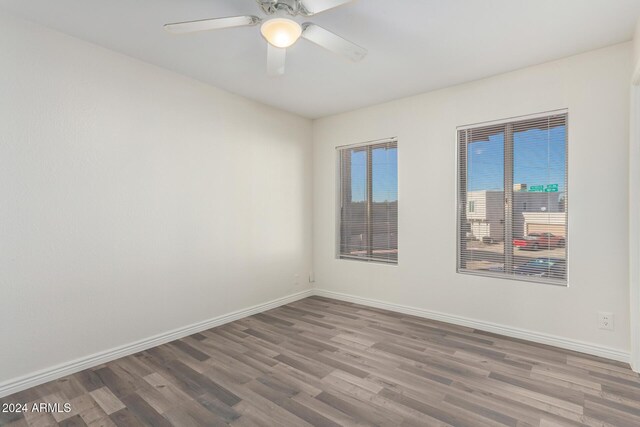 16053 N 26th Cir, Phoenix, AZ 85023 - unfurnished room featuring wood finished floors, a ceiling fan, and baseboards