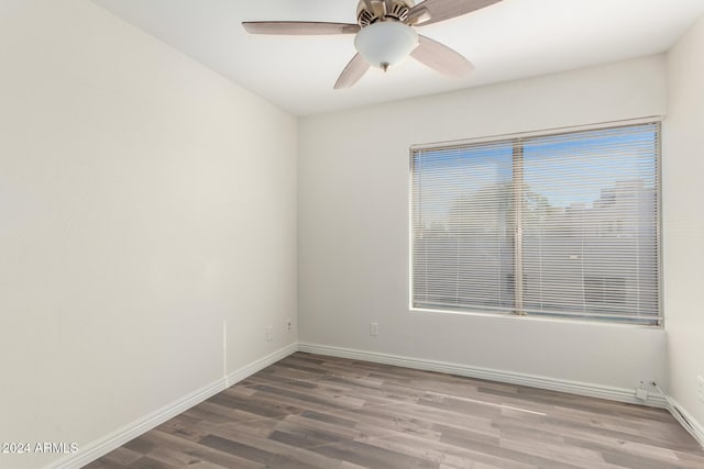 spare room featuring wood-type flooring and ceiling fan