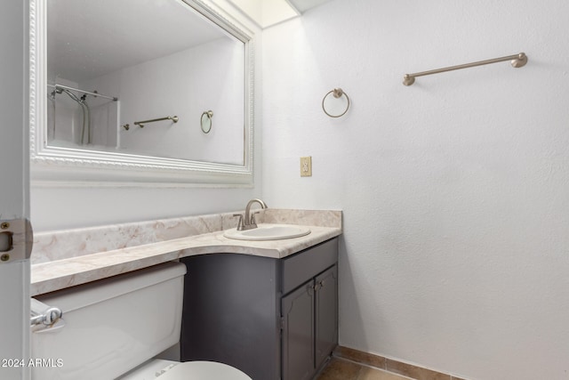 bathroom featuring tile patterned floors, vanity, and toilet