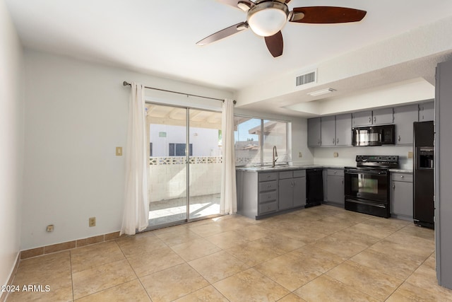 kitchen featuring gray cabinetry, ceiling fan, sink, light tile patterned flooring, and black appliances