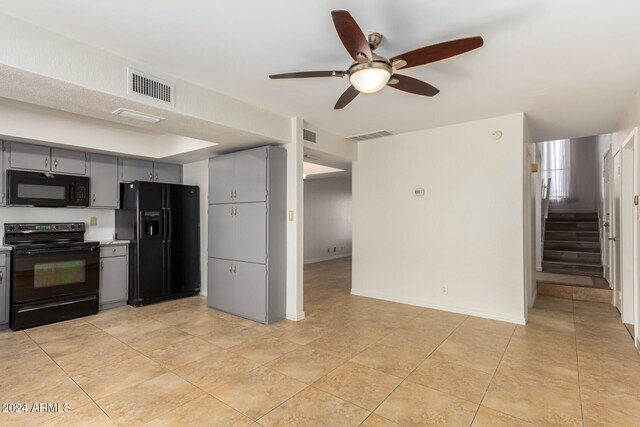 kitchen with light tile patterned floors, gray cabinets, ceiling fan, and black appliances