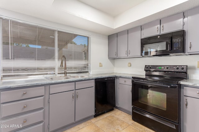 kitchen featuring gray cabinets, sink, light tile patterned flooring, and black appliances