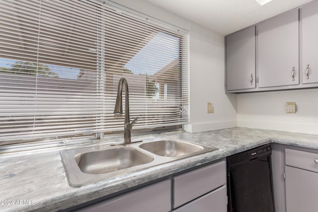16053 N 26th Cir, Phoenix, AZ 85023 - kitchen with black dishwasher, a sink, gray cabinetry, and plenty of natural light
