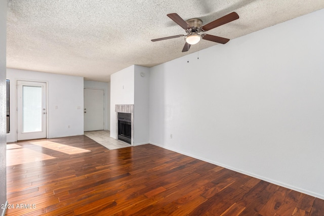 unfurnished living room featuring light wood-type flooring, ceiling fan, and a textured ceiling