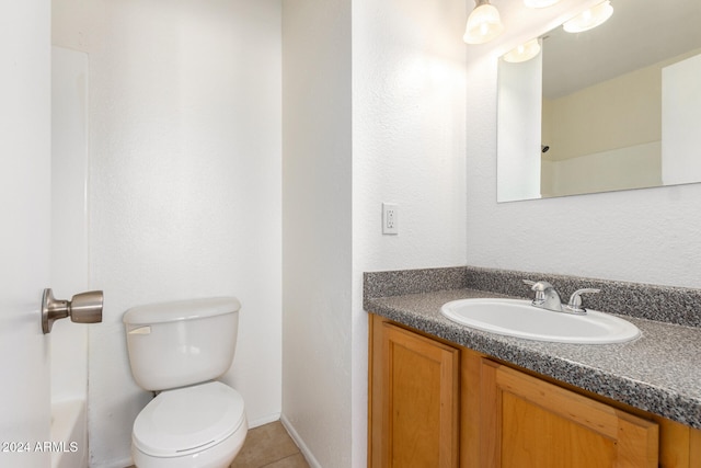 bathroom featuring toilet, tile patterned flooring, and vanity