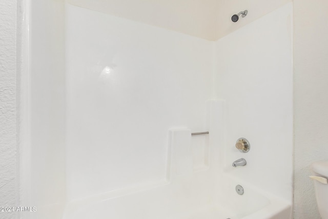 bathroom with toilet and shower / washtub combination