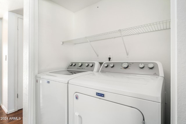 laundry room with dark hardwood / wood-style flooring and independent washer and dryer