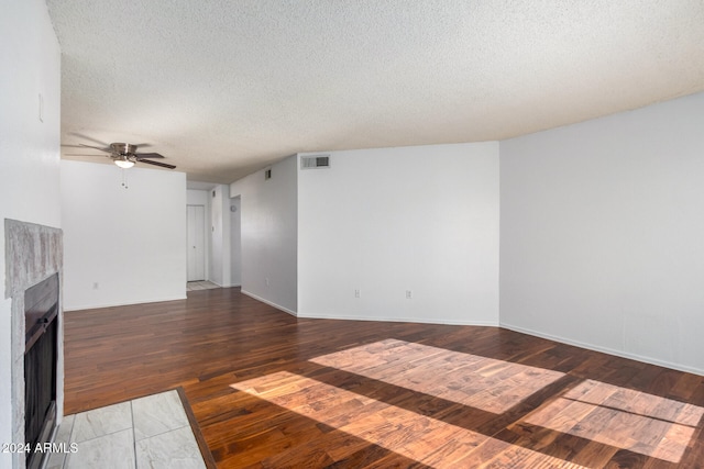 unfurnished living room with ceiling fan, a textured ceiling, and hardwood / wood-style floors