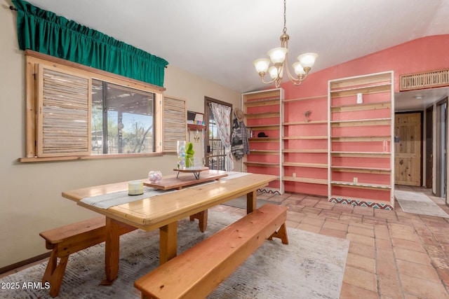 dining room featuring an inviting chandelier and vaulted ceiling