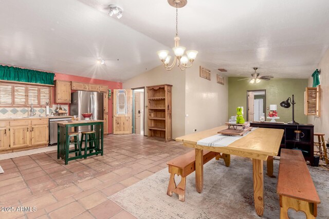 dining room featuring lofted ceiling and ceiling fan with notable chandelier