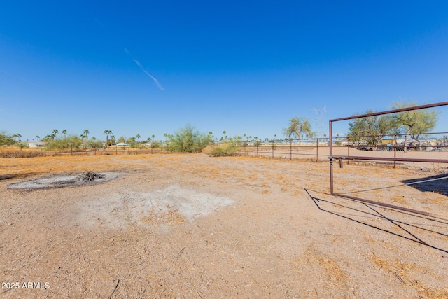 view of yard with a rural view, fence, and volleyball court