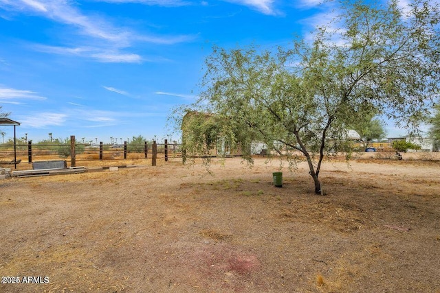 view of yard with a rural view and fence