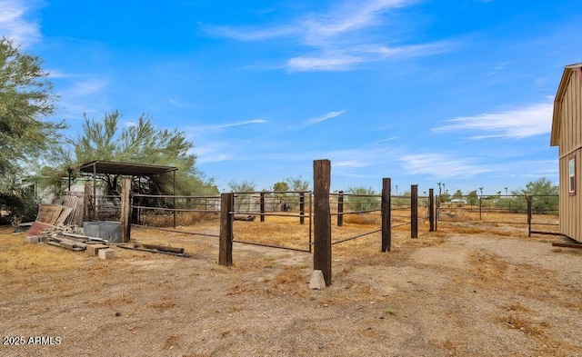 view of yard featuring a rural view and fence