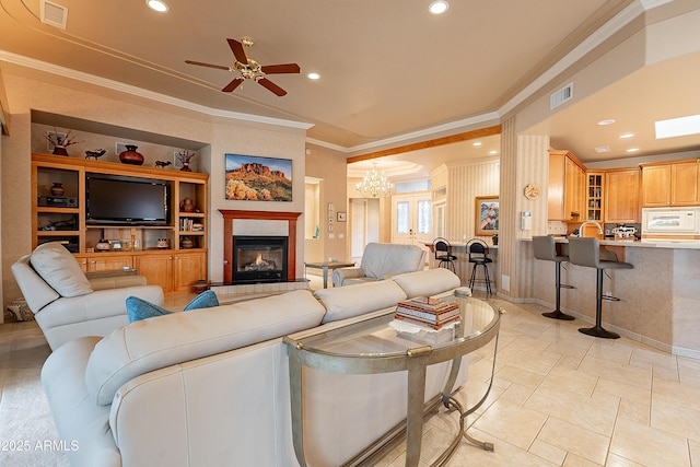 living room with recessed lighting, visible vents, and crown molding