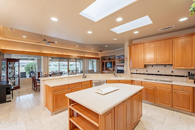 kitchen featuring visible vents, dishwasher, light countertops, a peninsula, and black electric cooktop