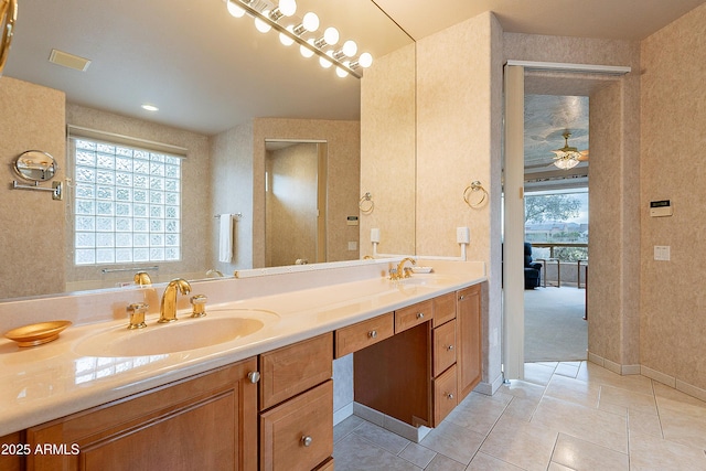 bathroom featuring a sink, a wealth of natural light, and double vanity