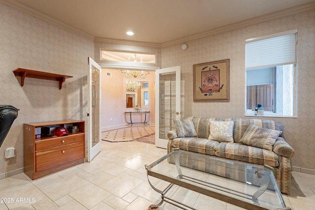 living room featuring a chandelier, baseboards, ornamental molding, and wallpapered walls