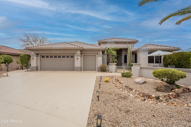 view of front facade featuring stucco siding, concrete driveway, an attached garage, and a tiled roof