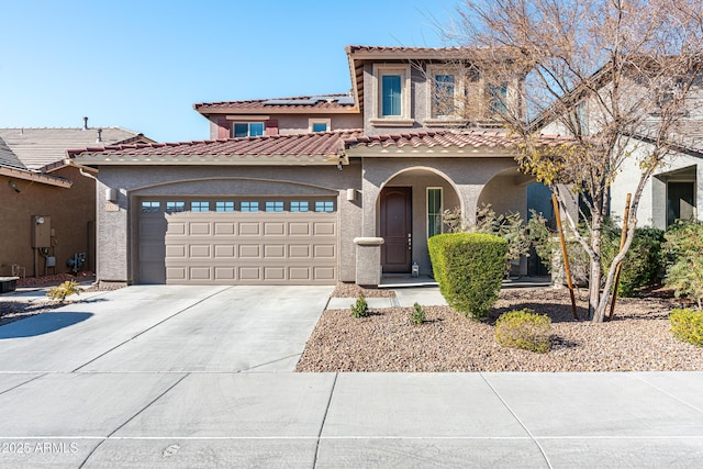 view of front of home with central air condition unit and a garage