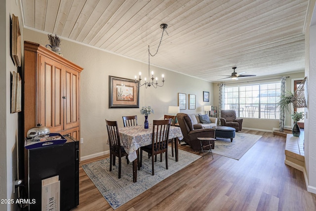 dining space featuring ceiling fan with notable chandelier, crown molding, wood ceiling, and dark hardwood / wood-style floors