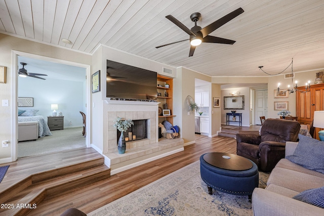 living room featuring wooden ceiling, a fireplace, hardwood / wood-style floors, and built in shelves