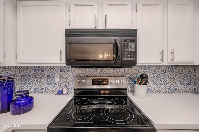 kitchen featuring white cabinets, decorative backsplash, and electric range