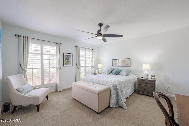 bedroom featuring ceiling fan and light colored carpet