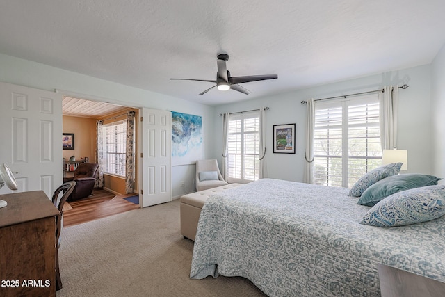 carpeted bedroom with a textured ceiling and ceiling fan