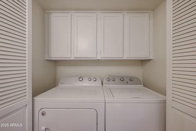 laundry area with cabinets and washer and clothes dryer