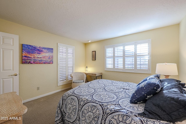 bedroom featuring a textured ceiling and carpet floors