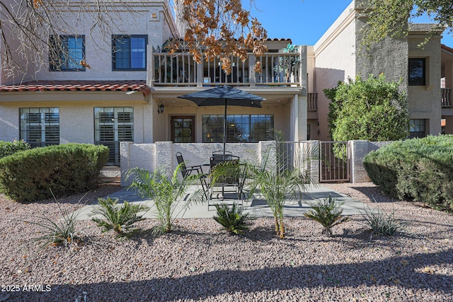 back of house with a patio area and a balcony