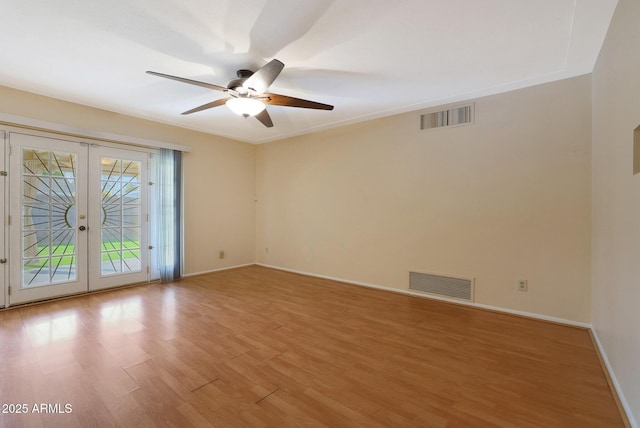 spare room featuring french doors, light hardwood / wood-style floors, and ceiling fan