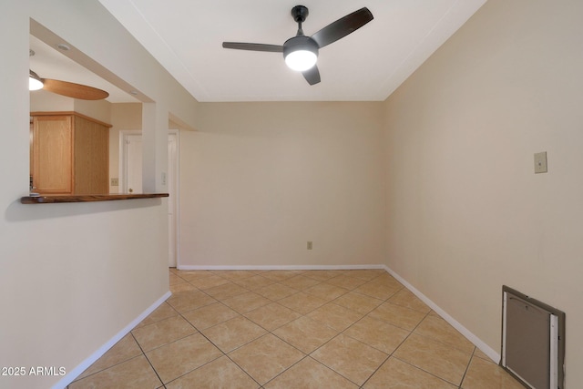 empty room featuring ceiling fan and light tile patterned floors