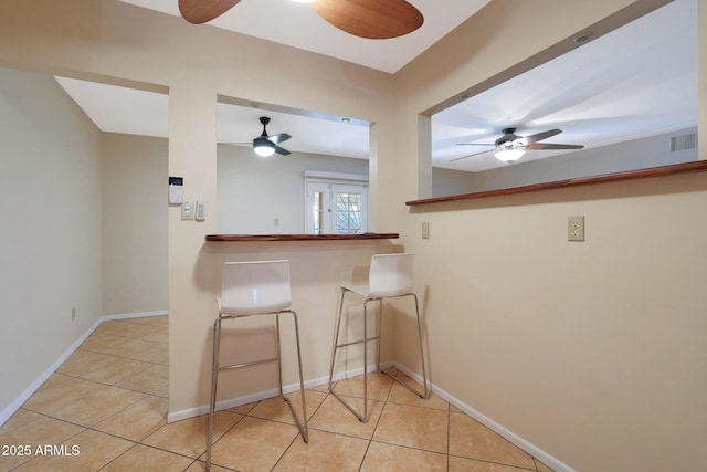 kitchen with ceiling fan and light tile patterned floors