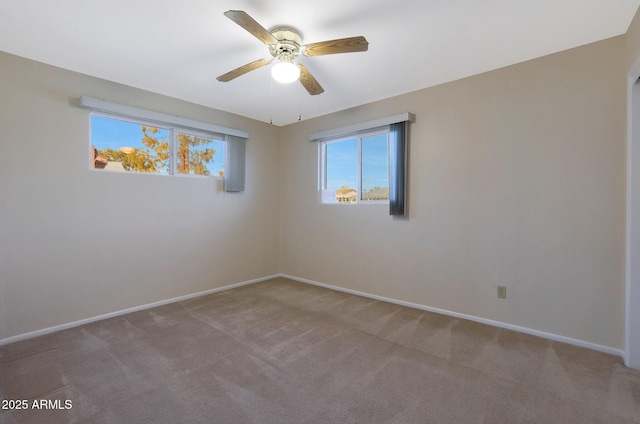 carpeted spare room with ceiling fan