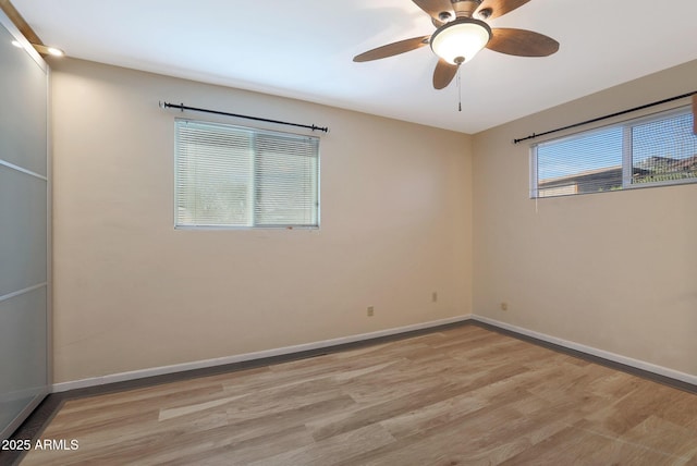 spare room featuring light hardwood / wood-style floors and ceiling fan