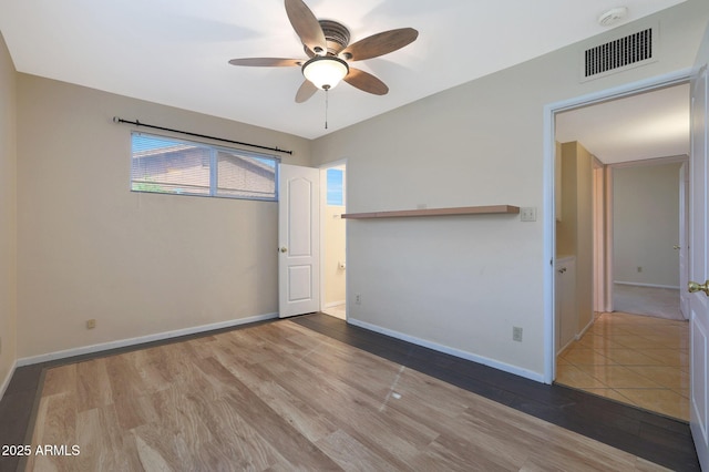 unfurnished room with hardwood / wood-style flooring and ceiling fan