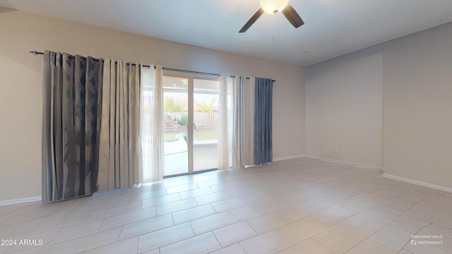 tiled spare room with ceiling fan