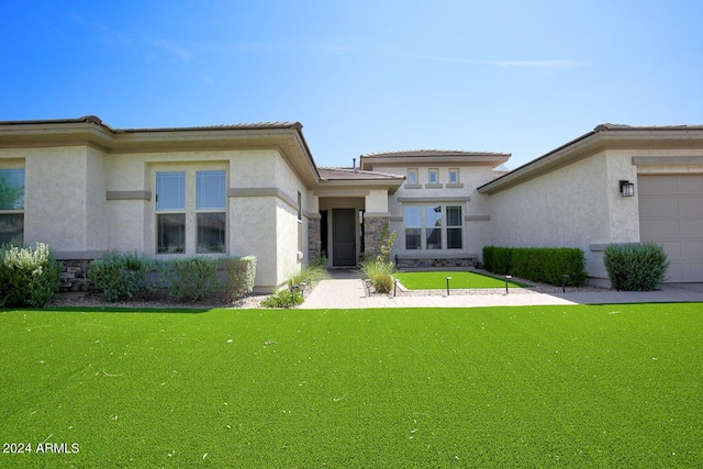 rear view of house featuring a lawn