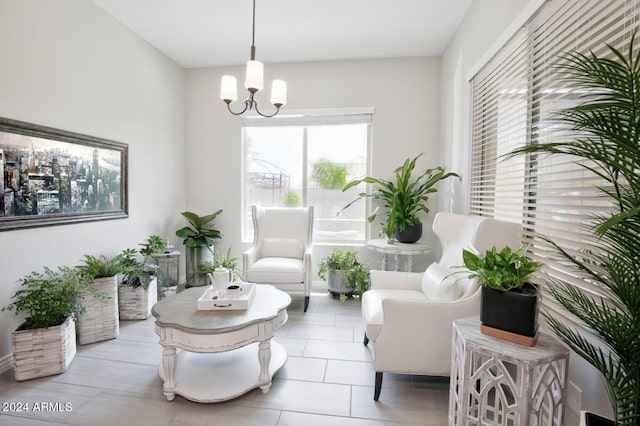 sitting room with light tile patterned floors and a notable chandelier