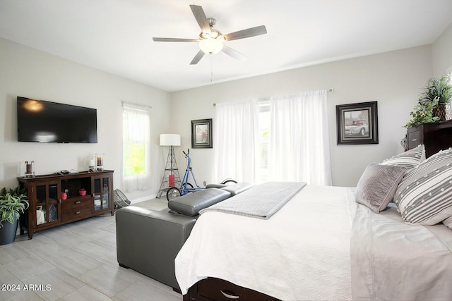 bedroom featuring multiple windows and ceiling fan