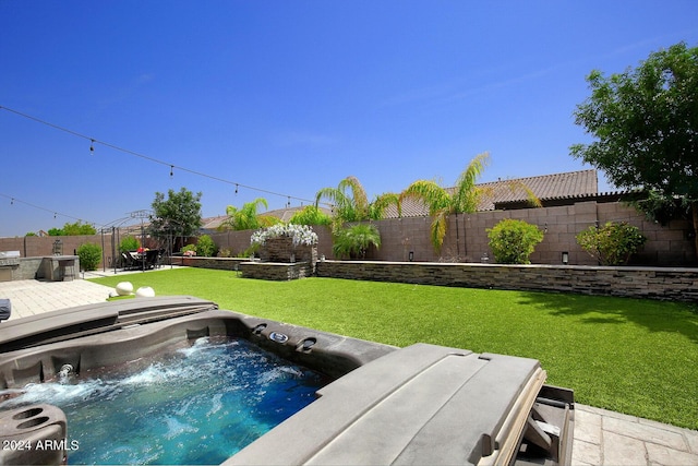 view of pool featuring a yard and a hot tub