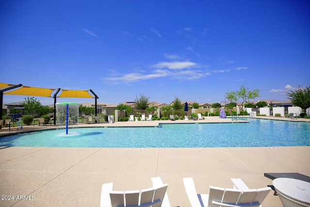 view of pool with a patio and pool water feature