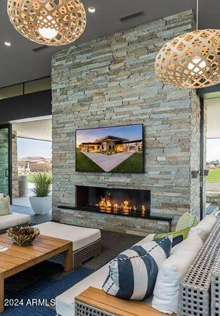 living room with a wealth of natural light and an outdoor stone fireplace