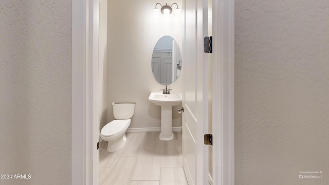 bathroom featuring sink and toilet