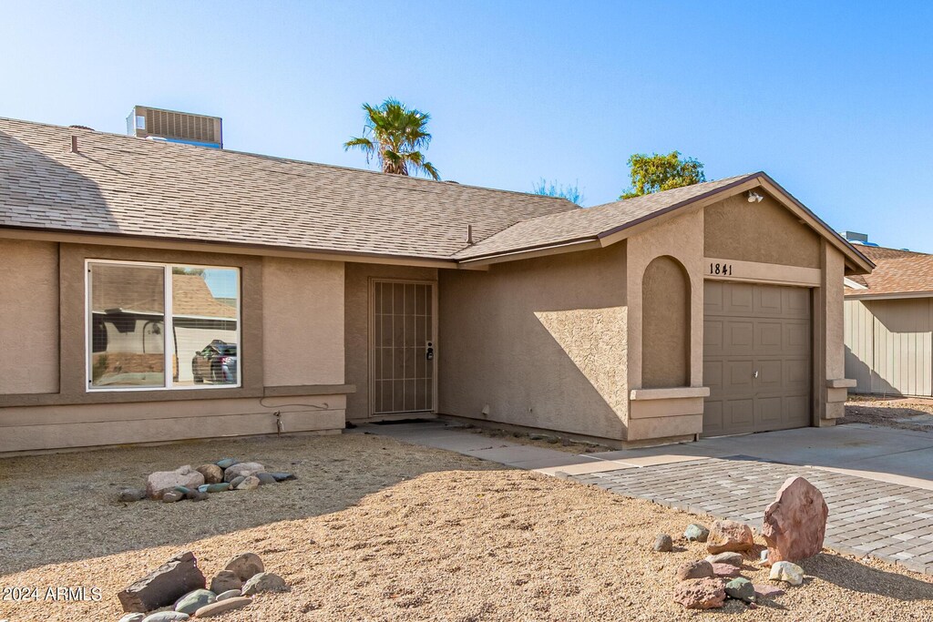 1841 E Kings Ave, Phoenix, AZ 85022 - single story home featuring driveway, a shingled roof, an attached garage, and stucco siding