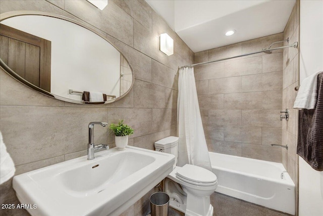 bathroom with backsplash, toilet, shower / bath combination with curtain, tile walls, and a sink