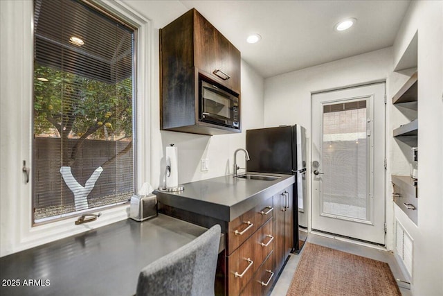 kitchen with a sink, a healthy amount of sunlight, recessed lighting, and black microwave