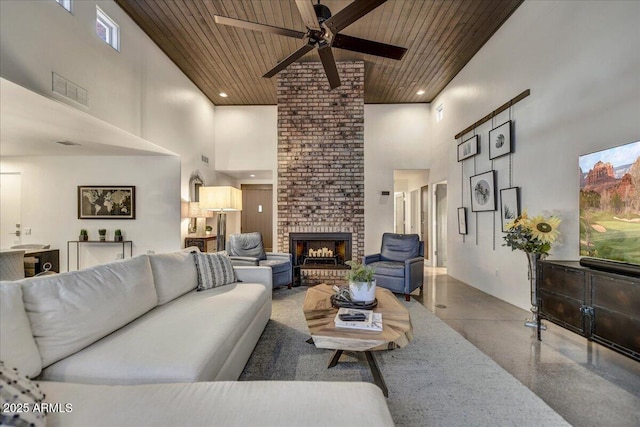 living room with a brick fireplace, recessed lighting, wood ceiling, and a towering ceiling