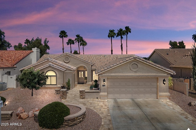 3394 N 147th Ln, Goodyear, AZ 85395 - view of front of house featuring driveway, a tiled roof, a garage, and stucco siding